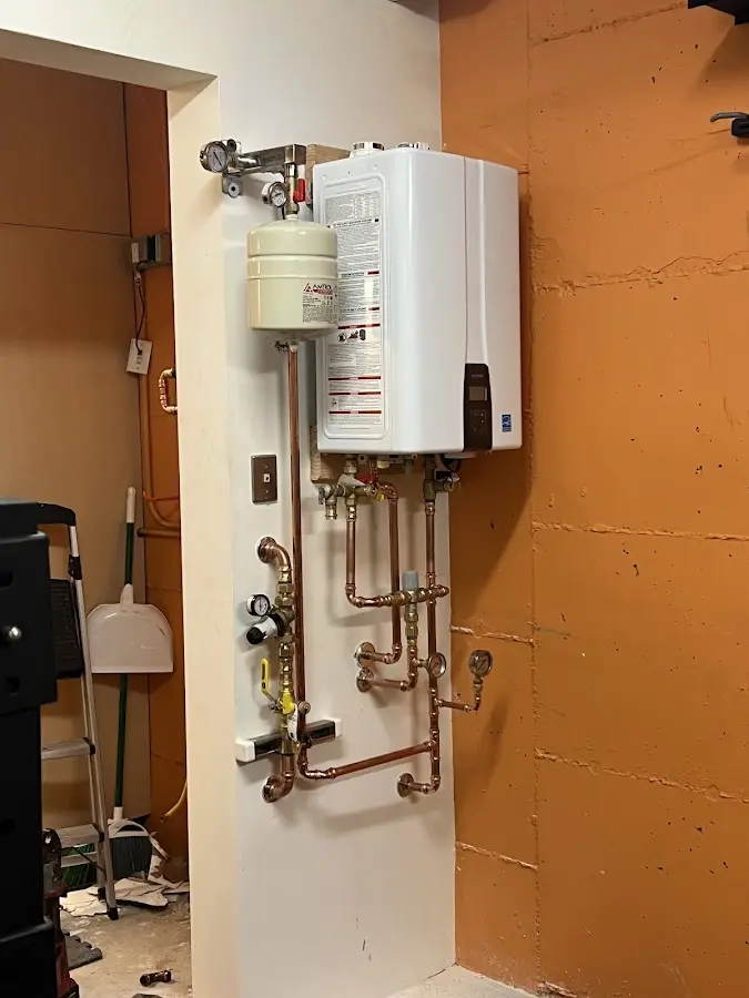 Plumbing technician inspecting water heater connections in Sevierville